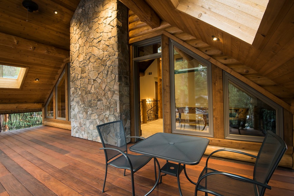 Inspiration for a mid-sized rustic rooftop deck remodel with a roof extension
