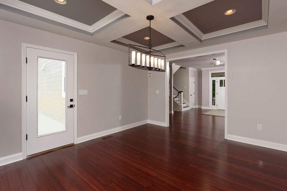 Design ideas for a mid-sized traditional entry hall in DC Metro with grey walls, bamboo floors, a single front door, a white front door and brown floor.