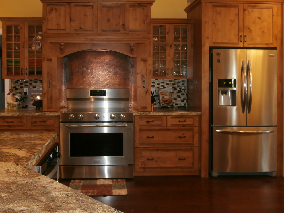 Eat-in kitchen - large rustic single-wall dark wood floor and brown floor eat-in kitchen idea with shaker cabinets, medium tone wood cabinets, laminate countertops, metallic backsplash, stainless steel appliances and two islands