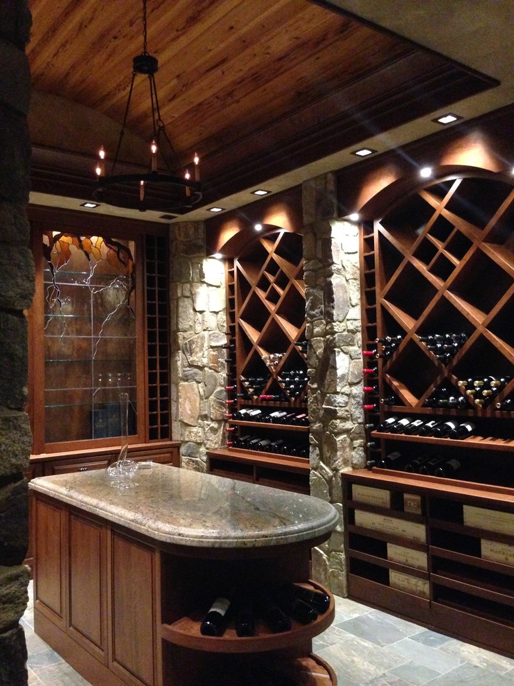Large country wine cellar in Raleigh with slate floors, diamond bins and grey floor.