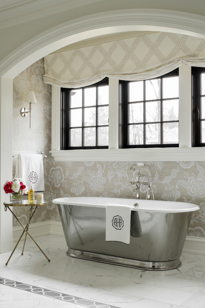 Traditional master bathroom in New York with a freestanding tub and beige walls.