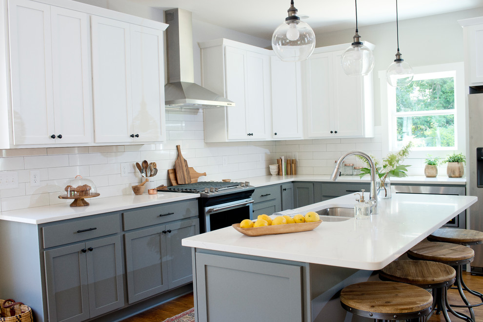 Kitchen - transitional l-shaped kitchen idea with stainless steel appliances and an island
