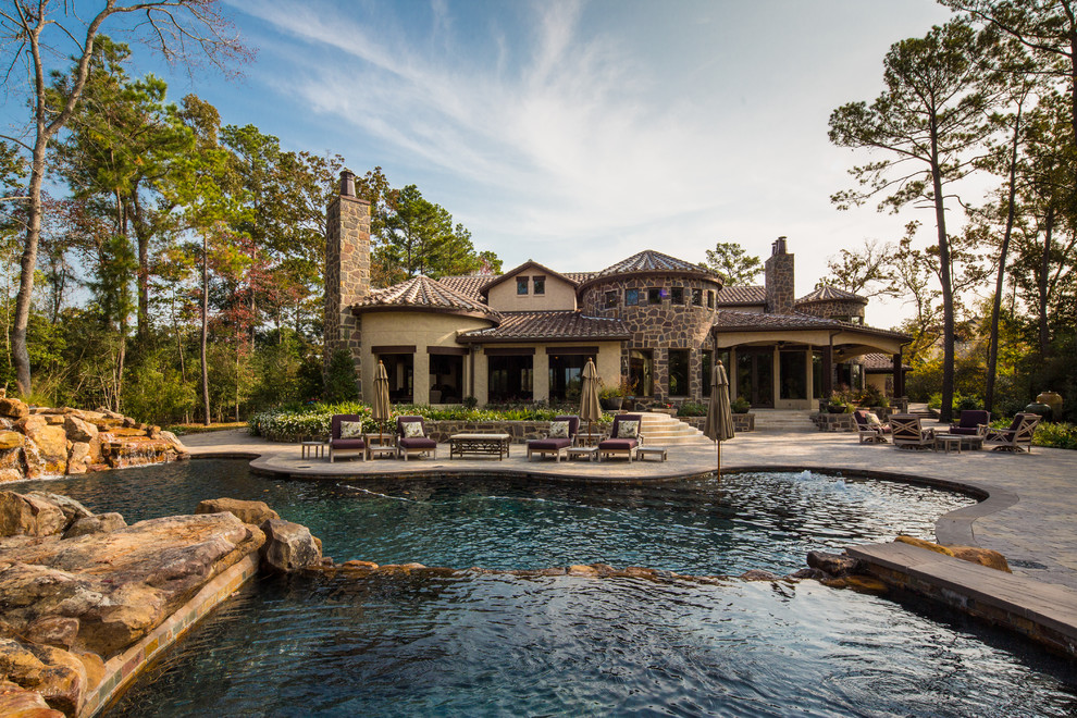 Mountain style backyard custom-shaped pool fountain photo in Houston
