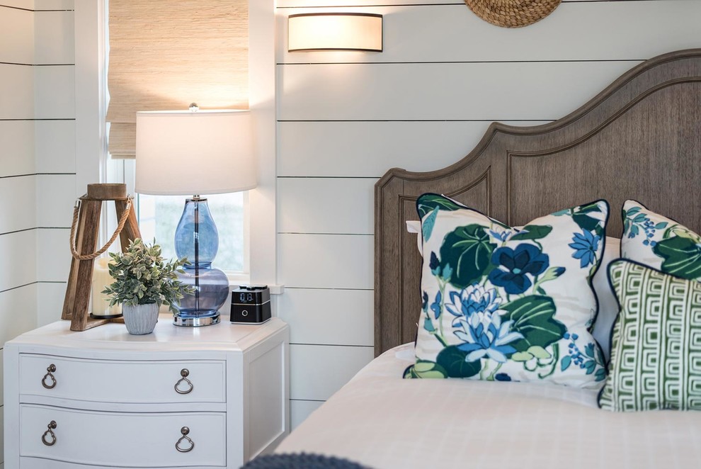 Mid-sized beach style bedroom in Atlanta with white walls, light hardwood floors, no fireplace and brown floor.