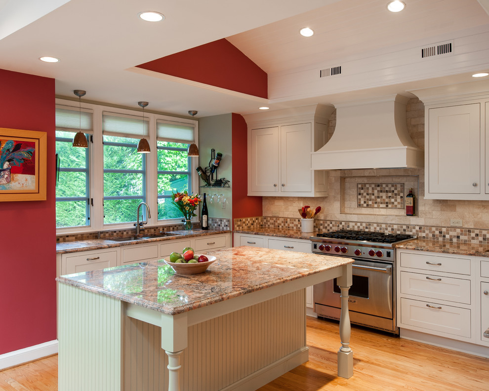 This is an example of a mid-sized traditional u-shaped separate kitchen in DC Metro with granite benchtops, stainless steel appliances, a double-bowl sink, shaker cabinets, white cabinets, beige splashback, porcelain splashback, light hardwood floors, with island and beige floor.