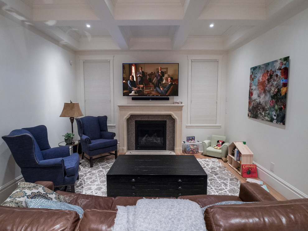 Photo of a mid-sized transitional enclosed living room in Edmonton with white walls, light hardwood floors, a standard fireplace, a tile fireplace surround and a wall-mounted tv.
