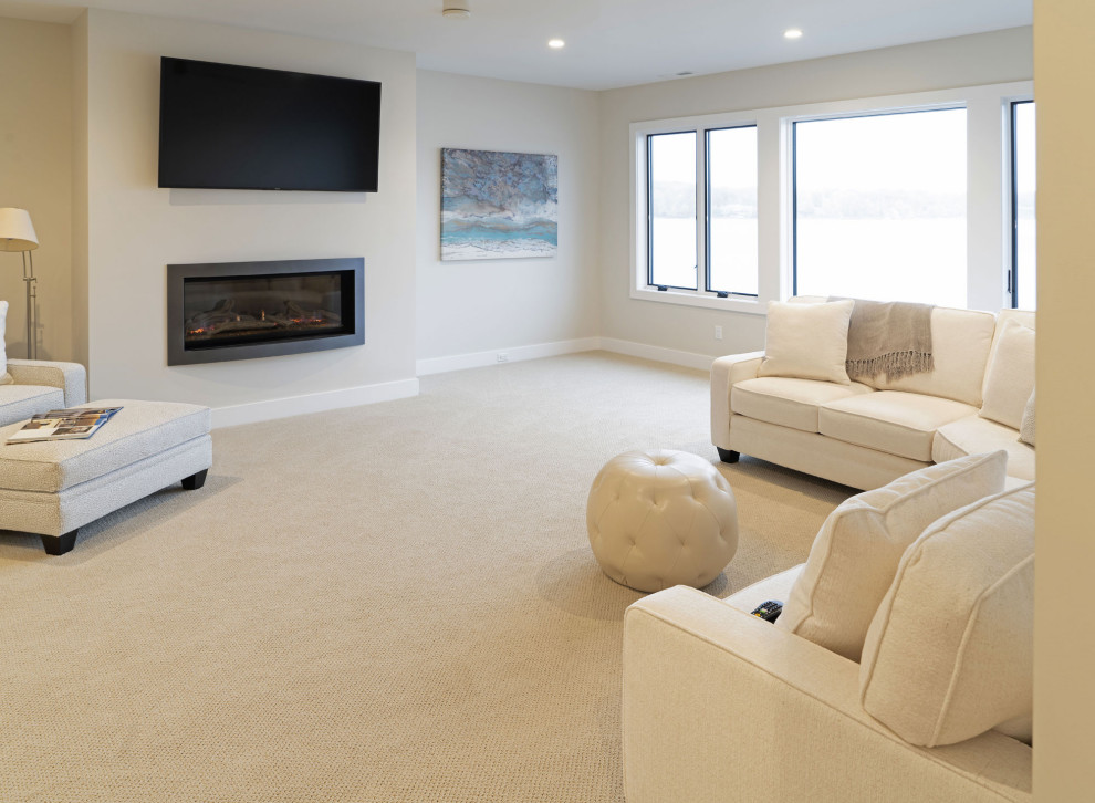 Immagine di un grande soggiorno tradizionale stile loft con pareti beige, moquette, camino classico, TV a parete e pavimento beige