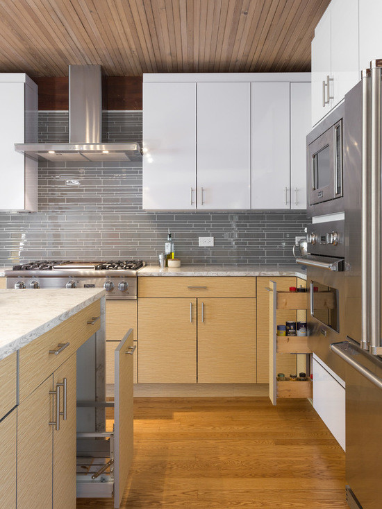Design ideas for a large modern l-shaped open plan kitchen in Chicago with an undermount sink, flat-panel cabinets, white cabinets, marble benchtops, grey splashback, subway tile splashback, stainless steel appliances, medium hardwood floors and with island.