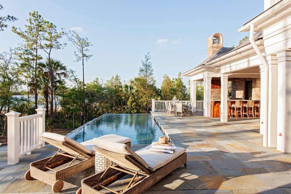Large traditional backyard rectangular infinity pool in Charleston.