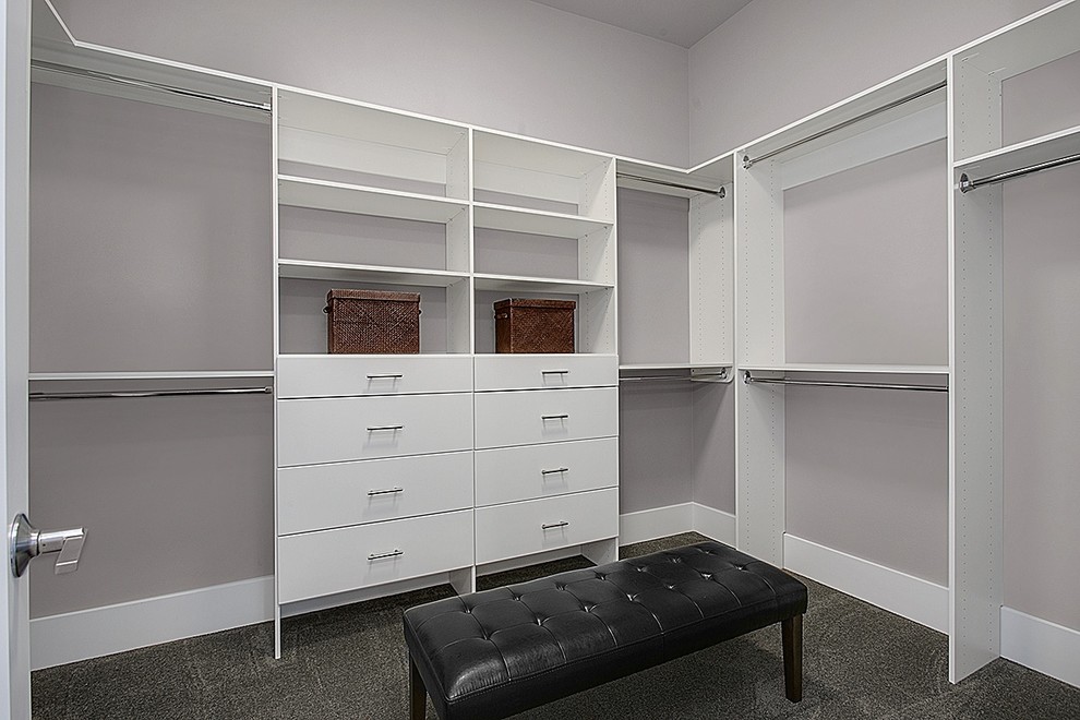 Design ideas for a modern gender-neutral walk-in wardrobe in Seattle with flat-panel cabinets, white cabinets and carpet.