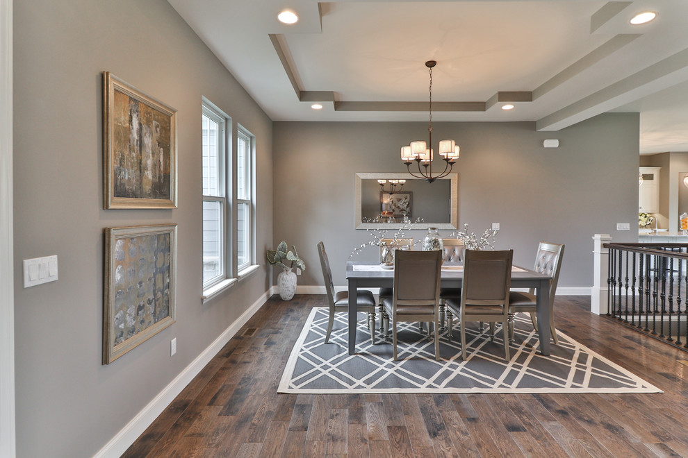 Photo of a mid-sized transitional open plan dining in St Louis with grey walls, dark hardwood floors, no fireplace and brown floor.