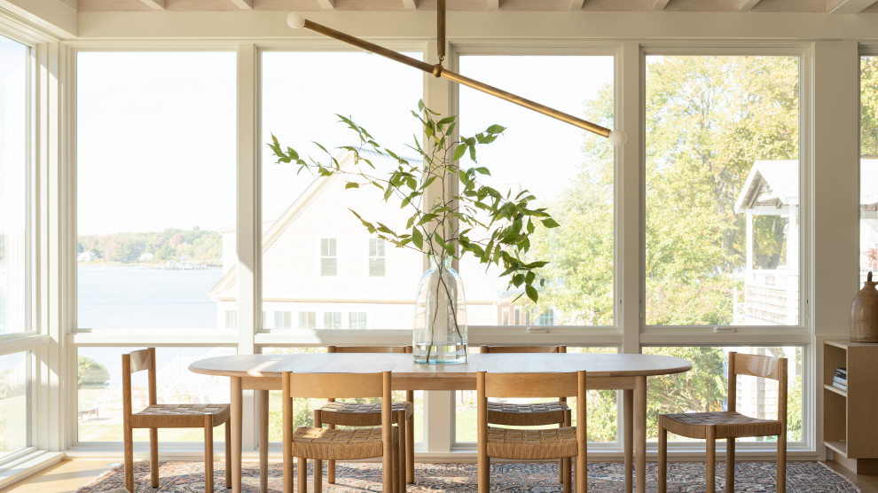Inspiration for a beach style dining room in Portland Maine with medium hardwood floors, brown floor and exposed beam.