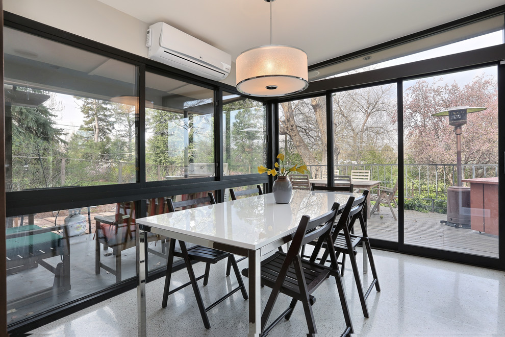 Photo of a midcentury dining room in Denver.