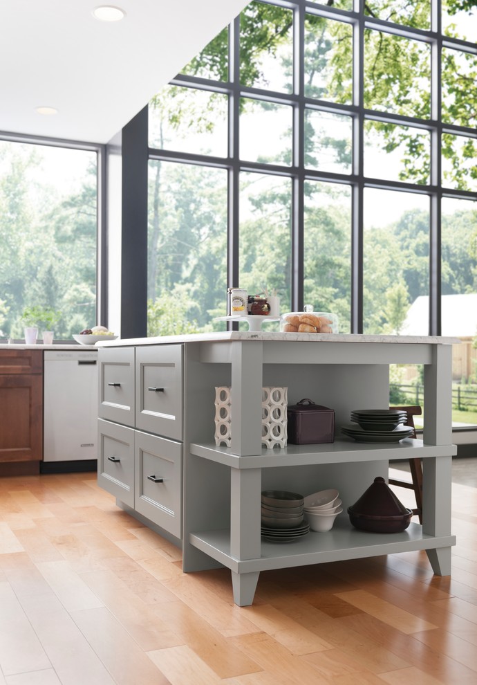 Inspiration for a transitional light wood floor and brown floor kitchen remodel with shaker cabinets, medium tone wood cabinets, marble countertops and an island