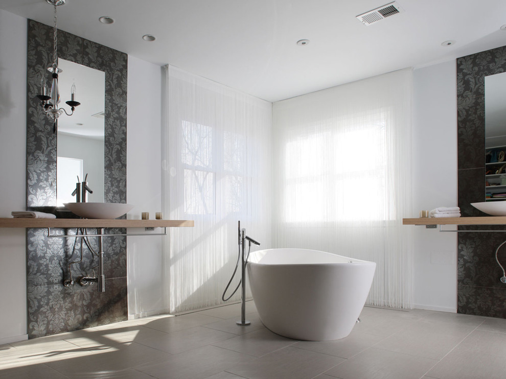 Inspiration for a modern bathroom in DC Metro with a freestanding tub and a vessel sink.