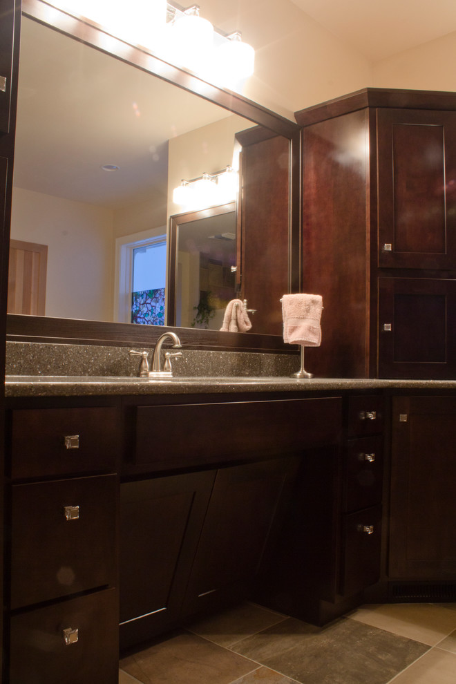 This is an example of a transitional master bathroom in Minneapolis with shaker cabinets, dark wood cabinets and an undermount sink.