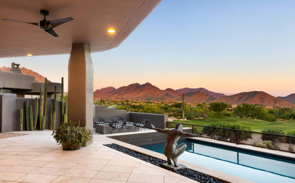 Huge minimalist backyard stone and rectangular infinity hot tub photo