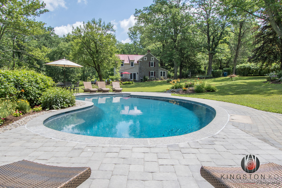 Transitional backyard kidney-shaped pool photo in Philadelphia