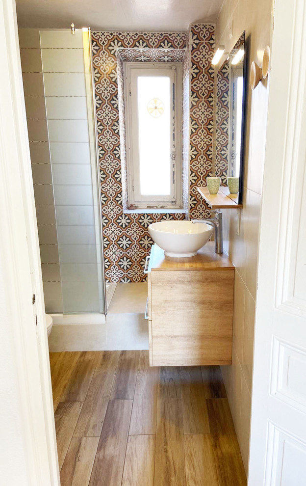 Design ideas for a small mediterranean 3/4 bathroom in Nice with light wood cabinets, a curbless shower, a one-piece toilet, multi-coloured tile, cement tile, beige walls, wood-look tile, a drop-in sink, wood benchtops, brown floor, an open shower, beige benchtops, a single vanity and a floating vanity.