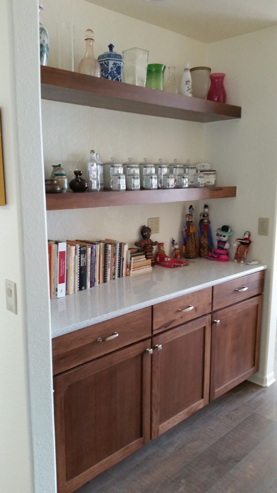 This is an example of a large modern kitchen pantry in Phoenix with an undermount sink, shaker cabinets, medium wood cabinets, white splashback, white appliances, medium hardwood floors, a peninsula and recycled glass benchtops.