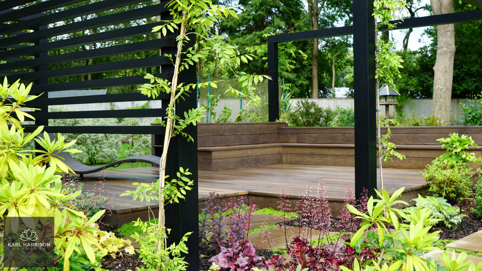 Inspiration for a large modern back formal and private full sun garden for summer in Buckinghamshire with decking and a wood fence.