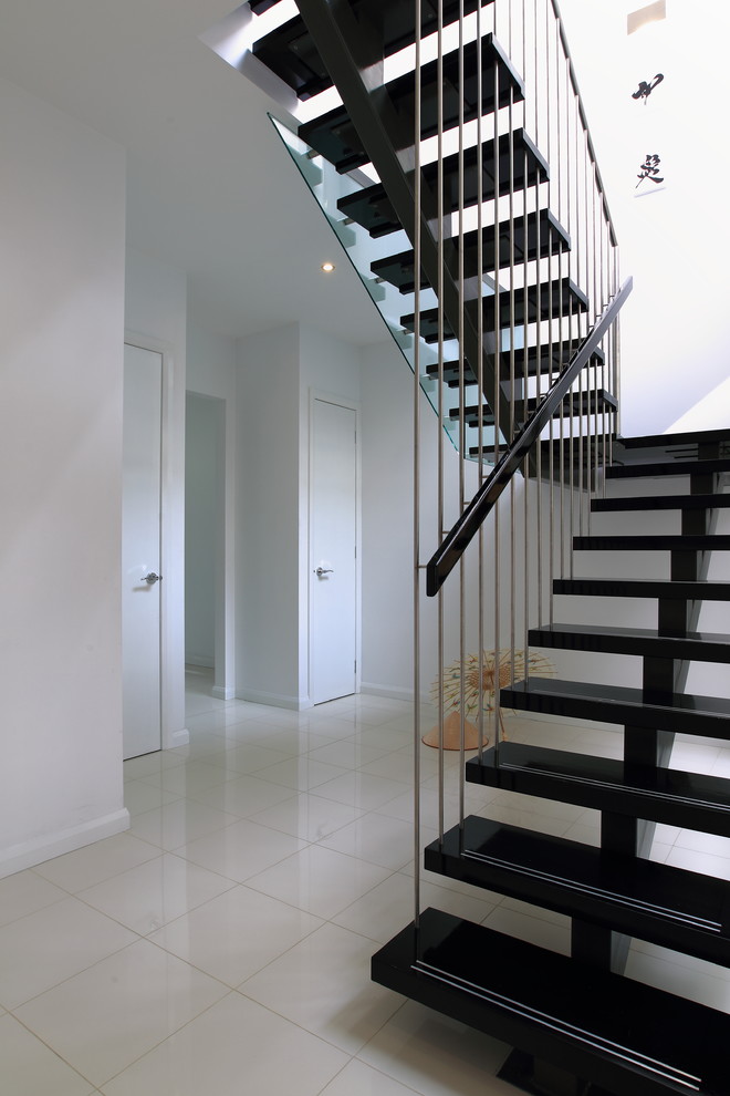 Inspiration for a large contemporary wood u-shaped staircase in Melbourne with open risers.