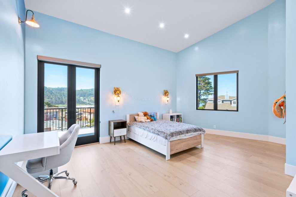 Light-Filled Bedroom with Balcony Access and Soft Blue Walls