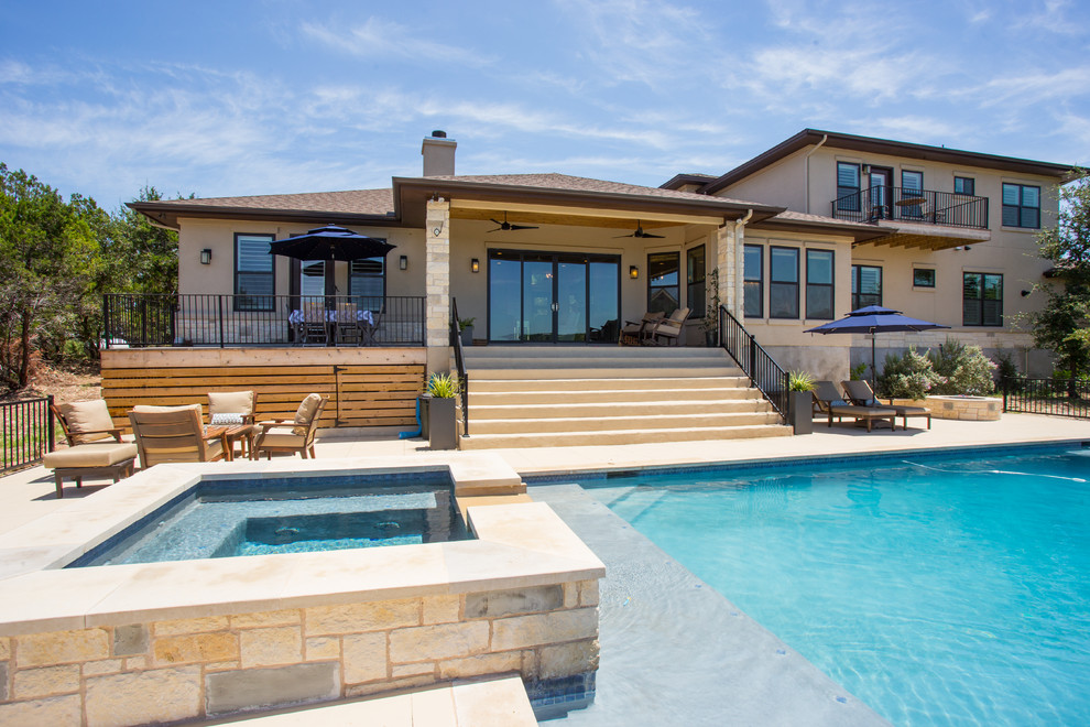 Large transitional backyard concrete and rectangular lap hot tub photo in Austin