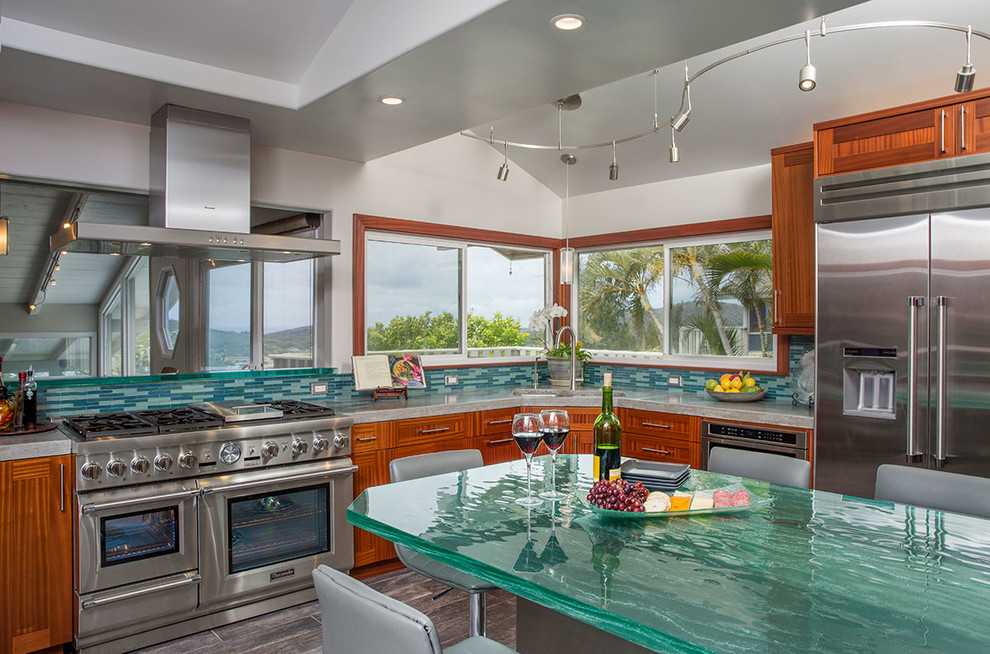 Inspiration for a large tropical eat-in kitchen in Hawaii with an undermount sink, shaker cabinets, medium wood cabinets, glass benchtops, multi-coloured splashback, glass tile splashback, stainless steel appliances, porcelain floors, no island and turquoise benchtop.