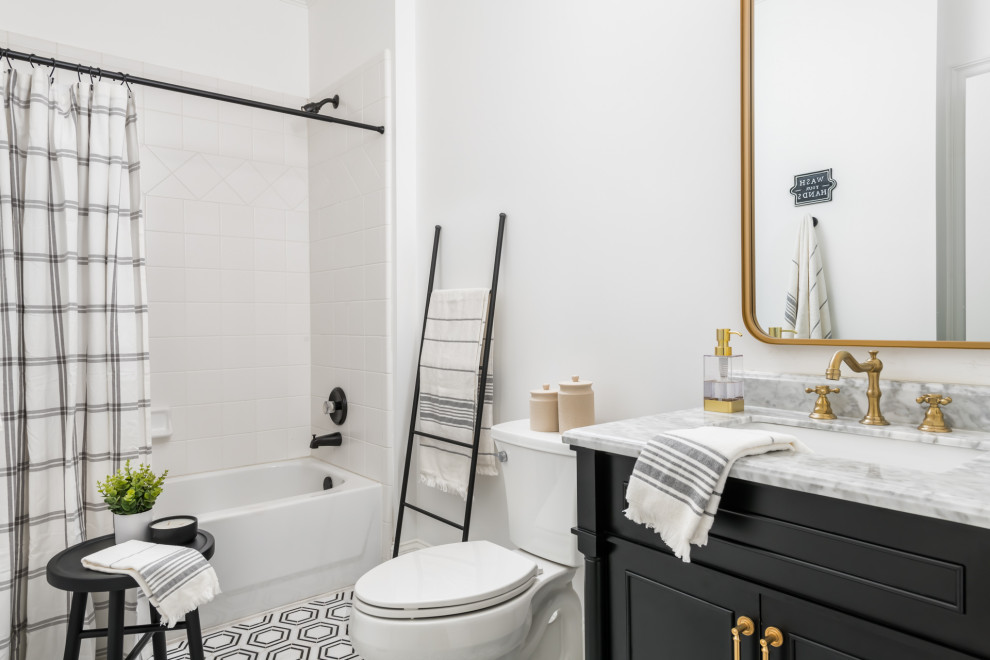 Photo of a large transitional bathroom in Atlanta with black cabinets, a two-piece toilet, white tile, ceramic tile, white walls, ceramic floors, an undermount sink, marble benchtops, multi-coloured floor, white benchtops, a freestanding vanity and recessed-panel cabinets.