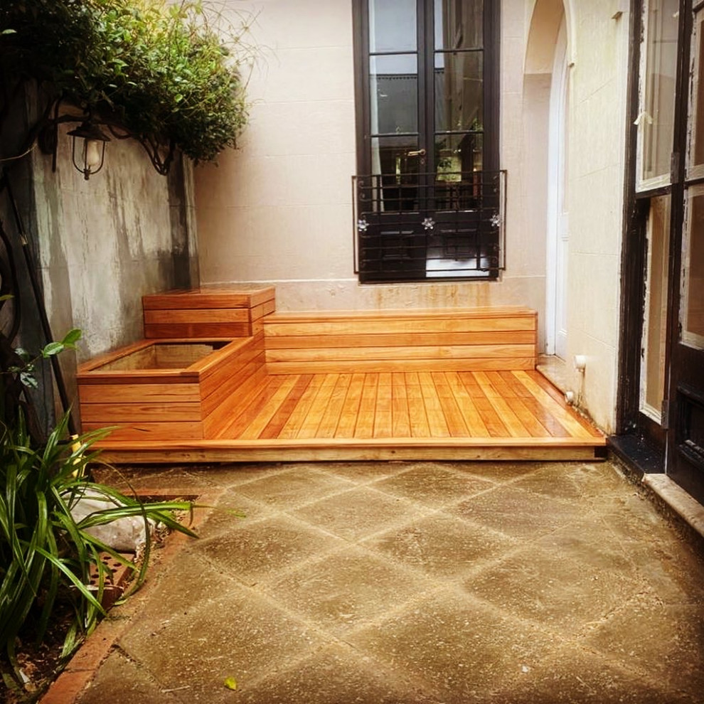 Photo of a small contemporary backyard deck in Sydney.