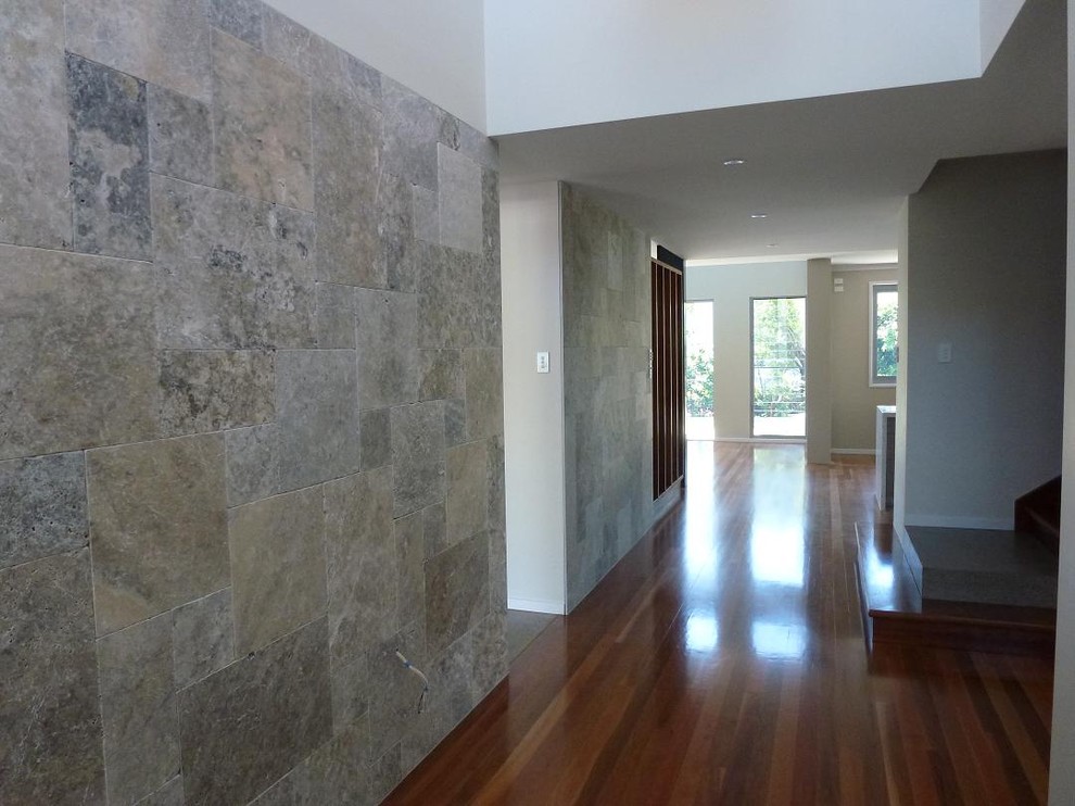 Design ideas for a large contemporary hallway in Brisbane with grey walls and medium hardwood floors.