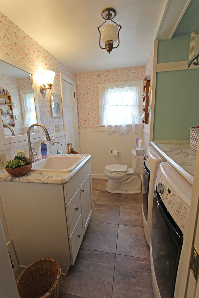 Inspiration for a small country 3/4 bathroom in Cleveland with a drop-in sink, recessed-panel cabinets, white cabinets, laminate benchtops, a two-piece toilet, white tile, green walls and a laundry.