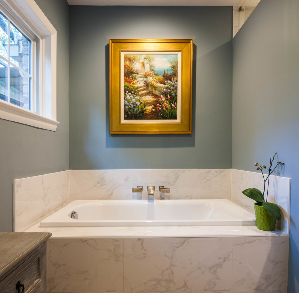Large transitional master white tile and ceramic tile ceramic tile and white floor drop-in bathtub photo in Atlanta with shaker cabinets, white cabinets, a one-piece toilet, blue walls, an undermount sink and granite countertops