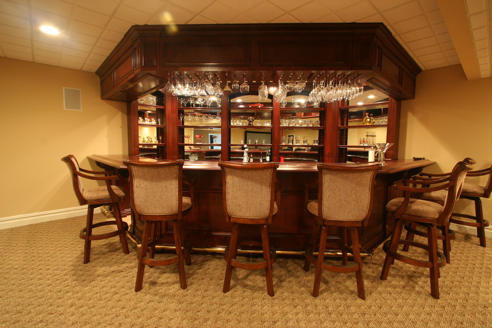 Inspiration for a large traditional u-shaped seated home bar in Philadelphia with dark wood cabinets, glass-front cabinets, granite benchtops, brown splashback, timber splashback and ceramic floors.