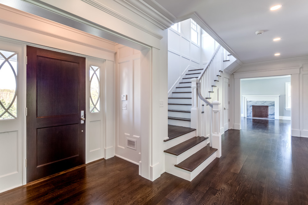 Huge transitional dark wood floor and brown floor front door photo with white walls and a dark wood front door