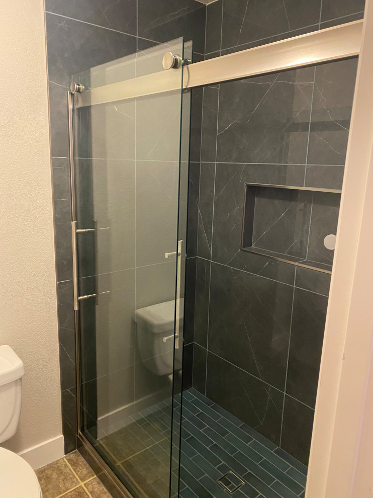 Design ideas for a medium sized contemporary ensuite bathroom in Portland with an alcove shower, black and white tiles, porcelain flooring, blue floors, a sliding door and a wall niche.