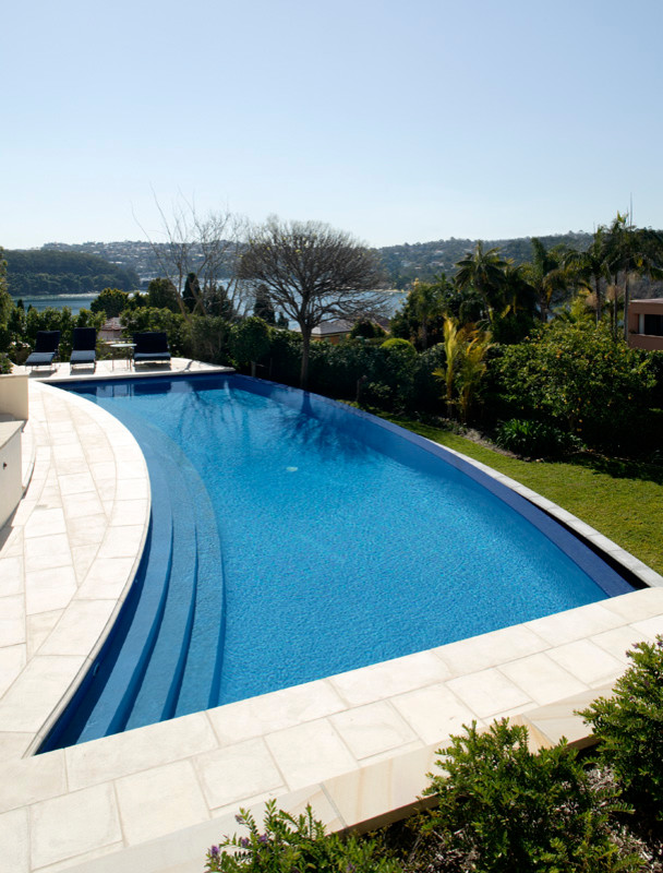 This is an example of a large contemporary front yard custom-shaped lap pool in Sydney.