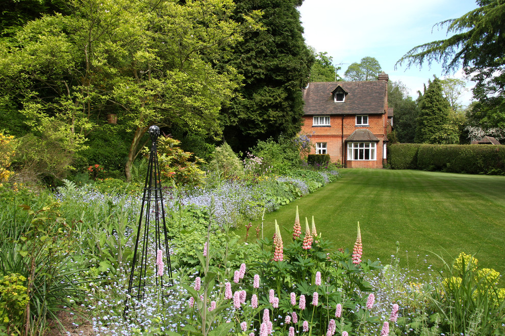 This is an example of a large traditional partial sun garden in Dorset.