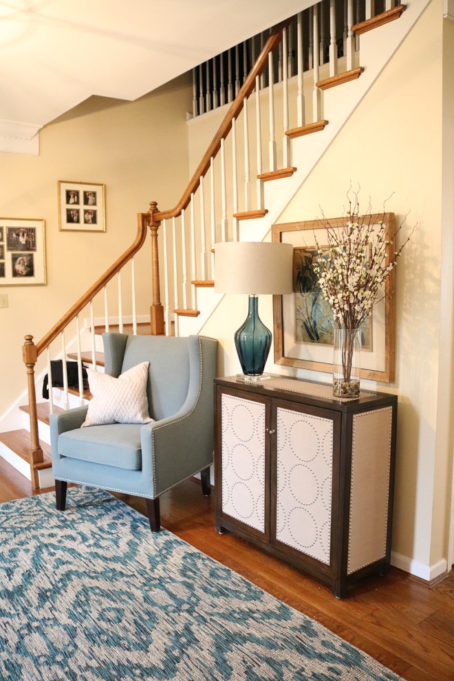 Small transitional medium tone wood floor foyer photo in Cincinnati with yellow walls