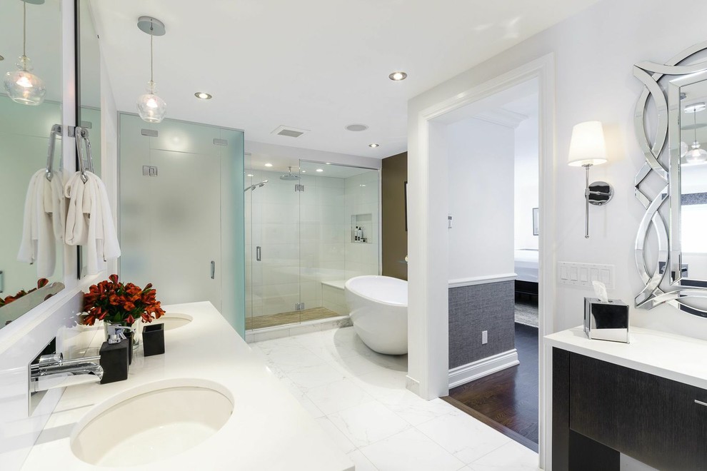 Large contemporary master bathroom in Ottawa with a freestanding tub, black cabinets, white tile, white walls, marble benchtops and marble floors.