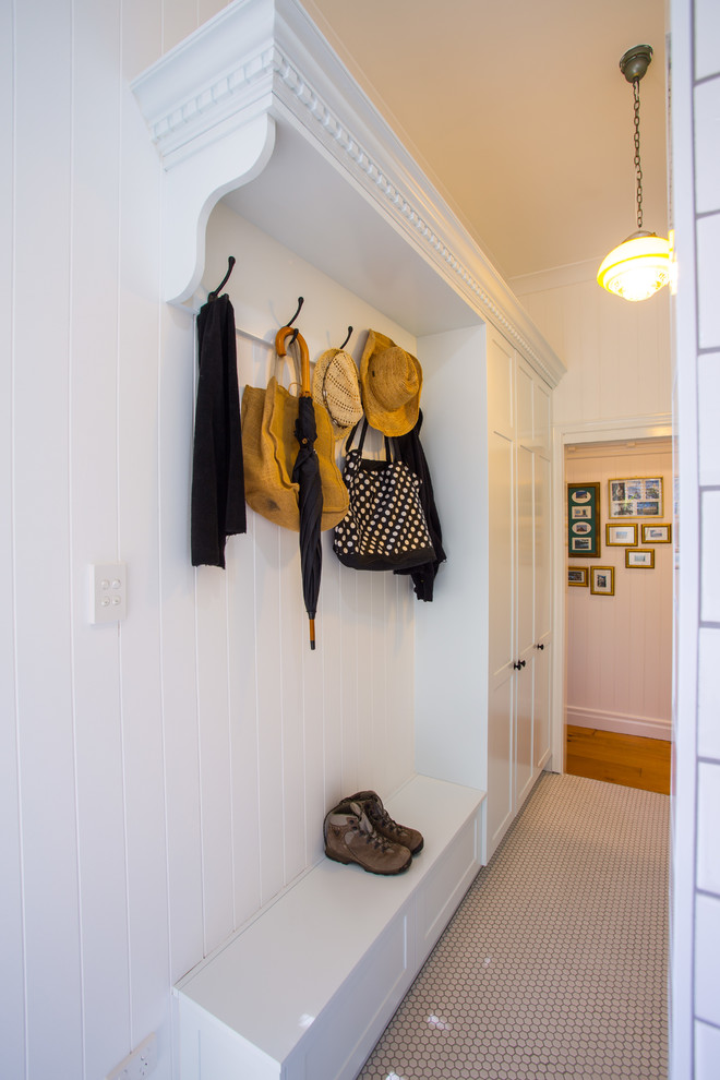 Inspiration for a large traditional entryway in Brisbane with white walls and ceramic floors.