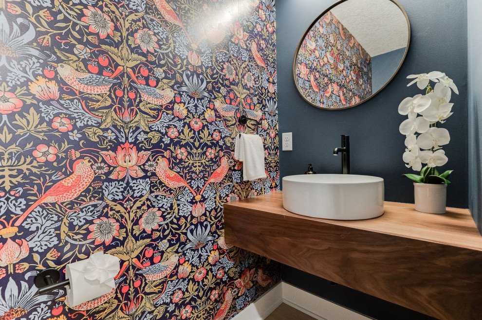 Mid-sized modern kids bathroom in Minneapolis with dark wood cabinets, a two-piece toilet, blue walls, vinyl floors, a vessel sink, wood benchtops, beige floor, a single vanity and a floating vanity.