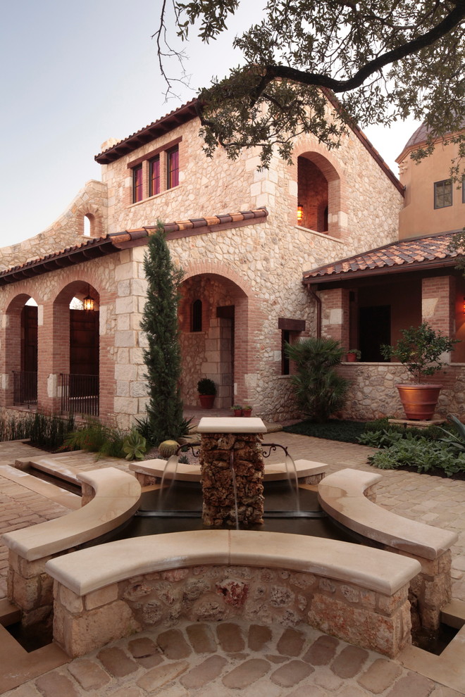 This is an example of a mediterranean exterior in Austin with stone veneer.