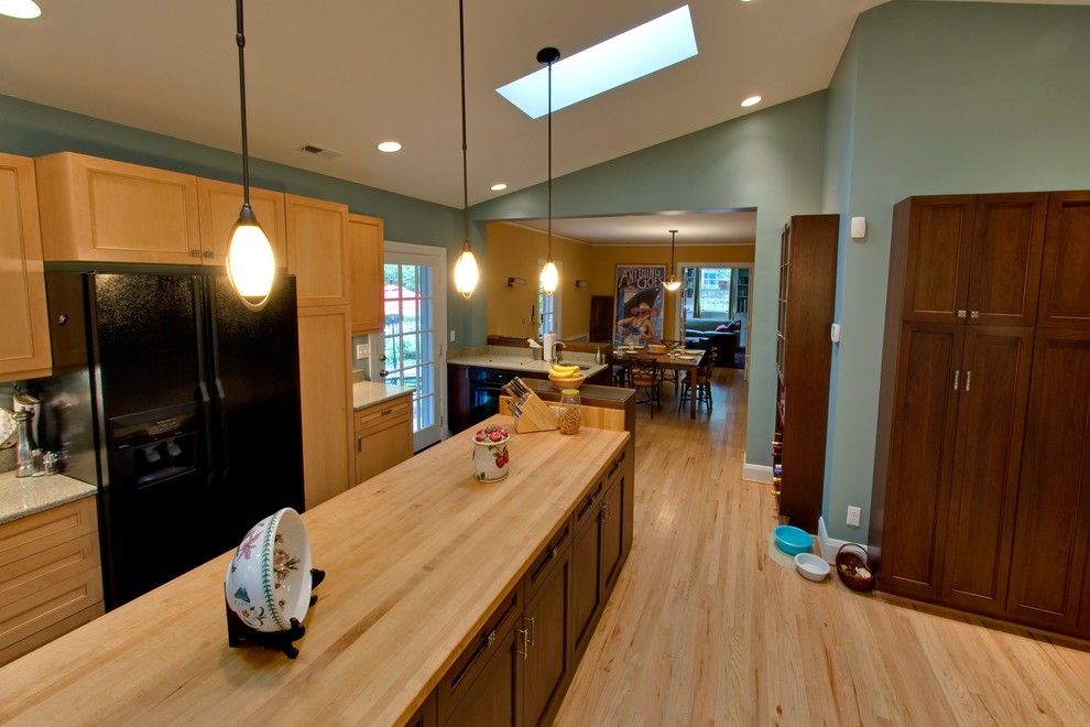 Photo of a large traditional single-wall kitchen in Baltimore with light wood cabinets, wood benchtops, medium hardwood floors and with island.