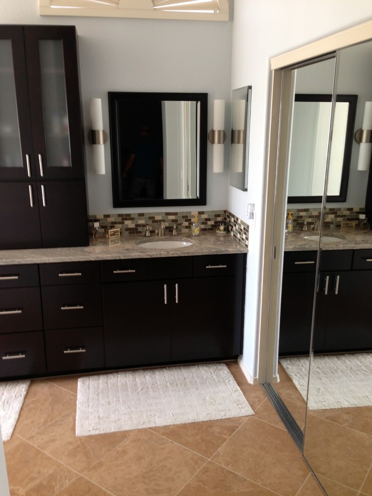 Photo of a large contemporary master bathroom in Phoenix with an integrated sink, flat-panel cabinets, dark wood cabinets, multi-coloured tile, glass tile, white walls and ceramic floors.