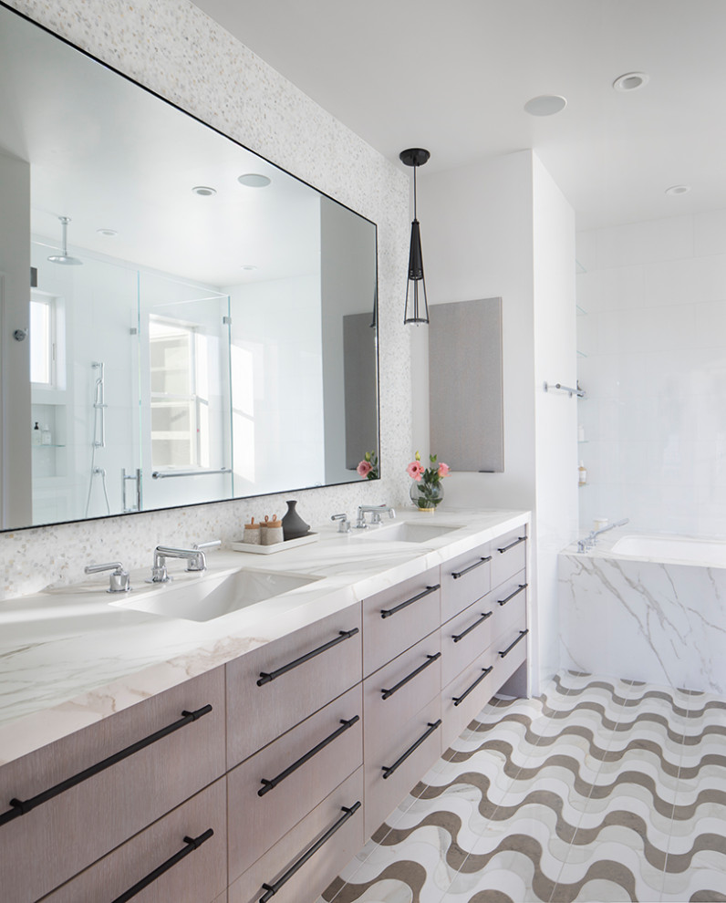 Photo of a large transitional master bathroom in San Francisco with flat-panel cabinets, light wood cabinets, an undermount tub, ceramic tile, ceramic floors, an undermount sink, a double vanity and a floating vanity.