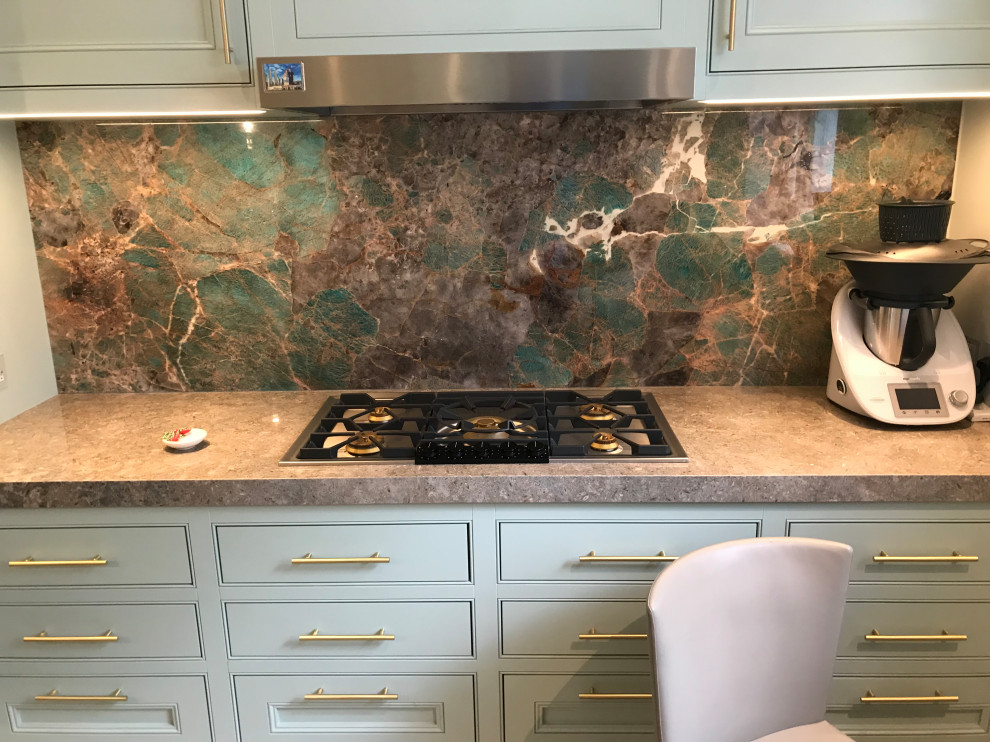 Design ideas for a large contemporary galley open plan kitchen in London with limestone benchtops, multi-coloured splashback, stone slab splashback, limestone floors, with island, beige floor and brown benchtop.