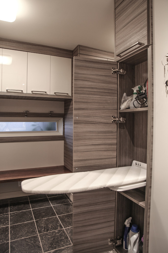 Example of a mid-sized transitional l-shaped slate floor home design design in Calgary with an utility sink, flat-panel cabinets, gray cabinets, beige walls and a side-by-side washer/dryer