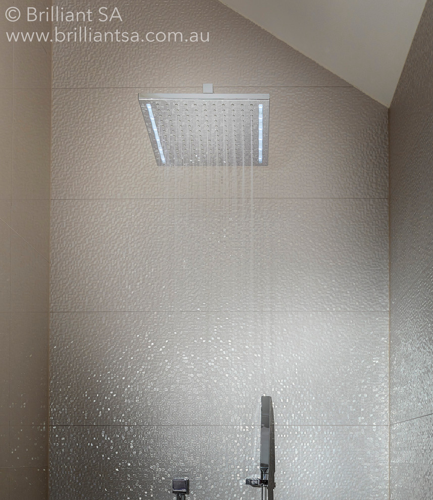 Inspiration for a small contemporary 3/4 bathroom in Adelaide with a corner shower, white tile, cement tile, white walls and ceramic floors.